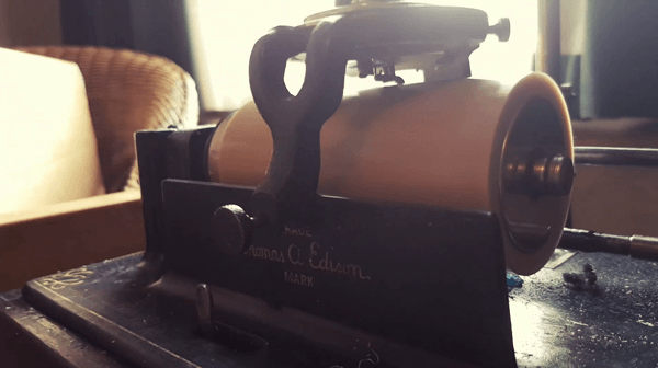 Close up moving image of a wax cylinder turning on a Thomas Edison phonograph.
